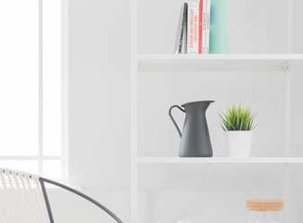 White Floating Wall Shelves Against a White Wall Help Make the Room Appear Larger